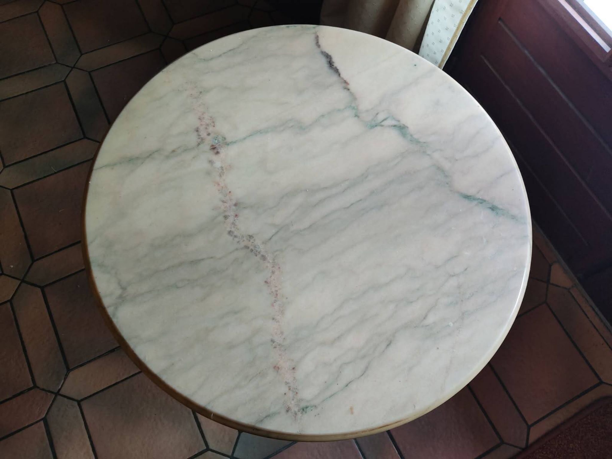 Round coffee table with a brass frame.