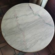 Round coffee table with a brass frame.