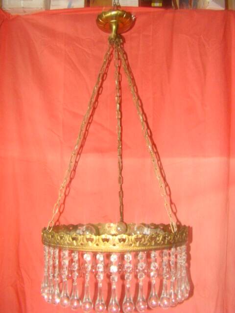 circular chandelier with a brass frame and crystal drops