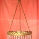 circular chandelier with a brass frame and crystal drops