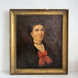Old oil painting on canvas portrait of a woman with a red bow, late 19th century
