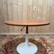 Round dining table with tulip base, 1960s design.