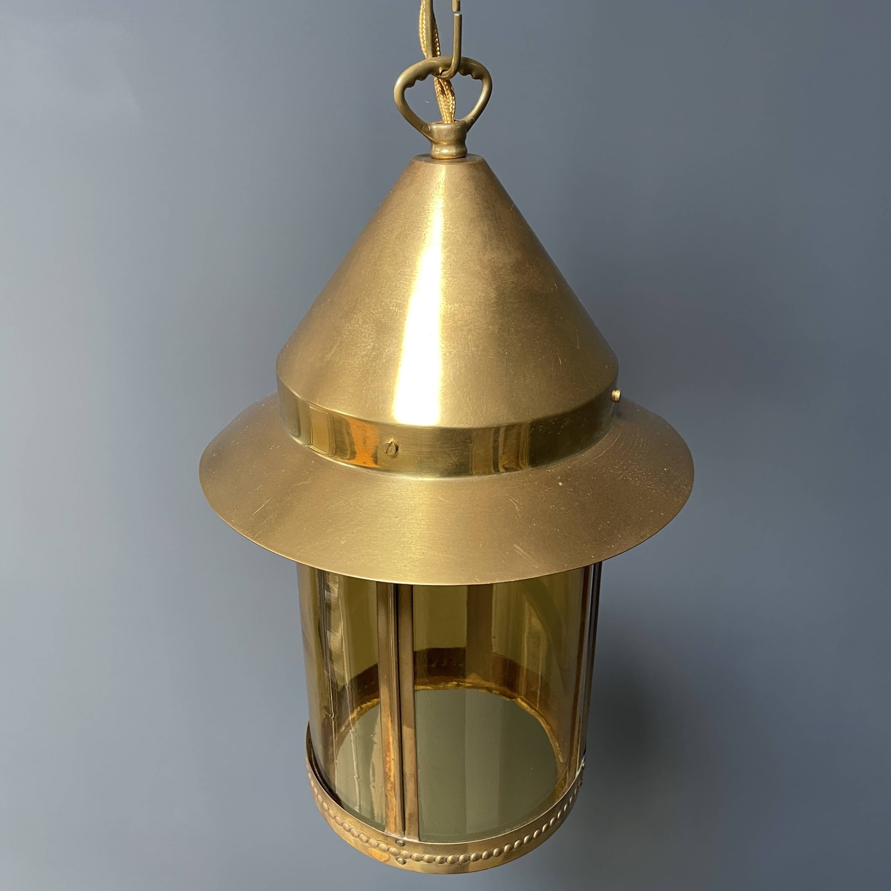Brass lantern pendant lamp with yellow glass