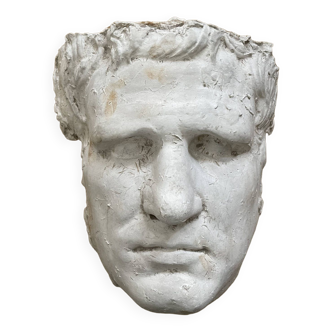 Face of a man in old plaster