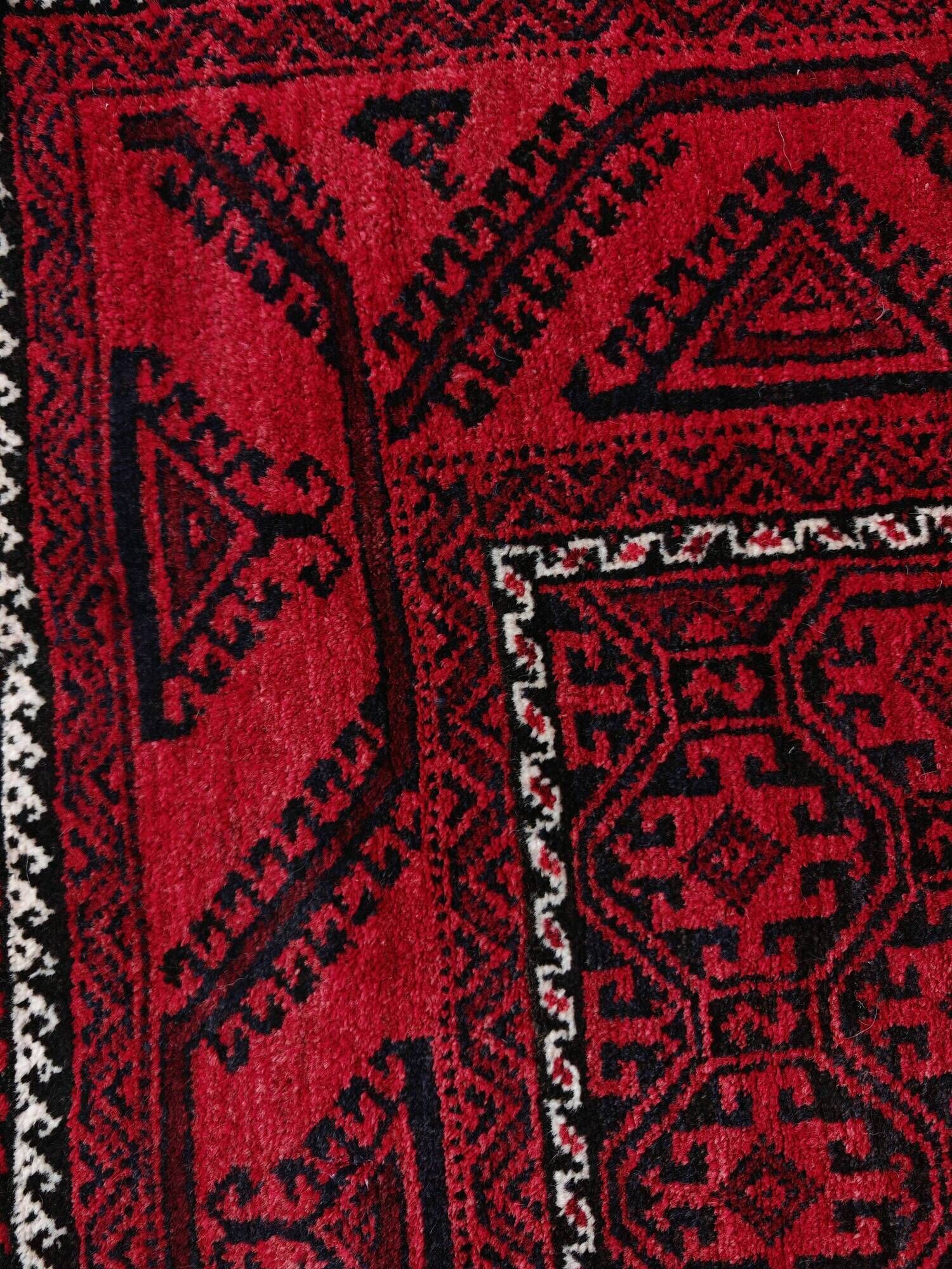 Vintage handmade Baluch rug with geometric pattern from the 1950s.