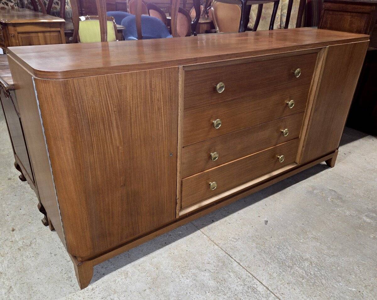 According to André Arbus, a sideboard in a row from the Art Deco period in blonde mahogany.