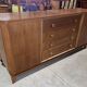 According to André Arbus, a sideboard in a row from the Art Deco period in blonde mahogany.