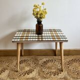 Small mosaic bedside table with tapered legs.