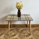 Small mosaic bedside table with tapered legs.