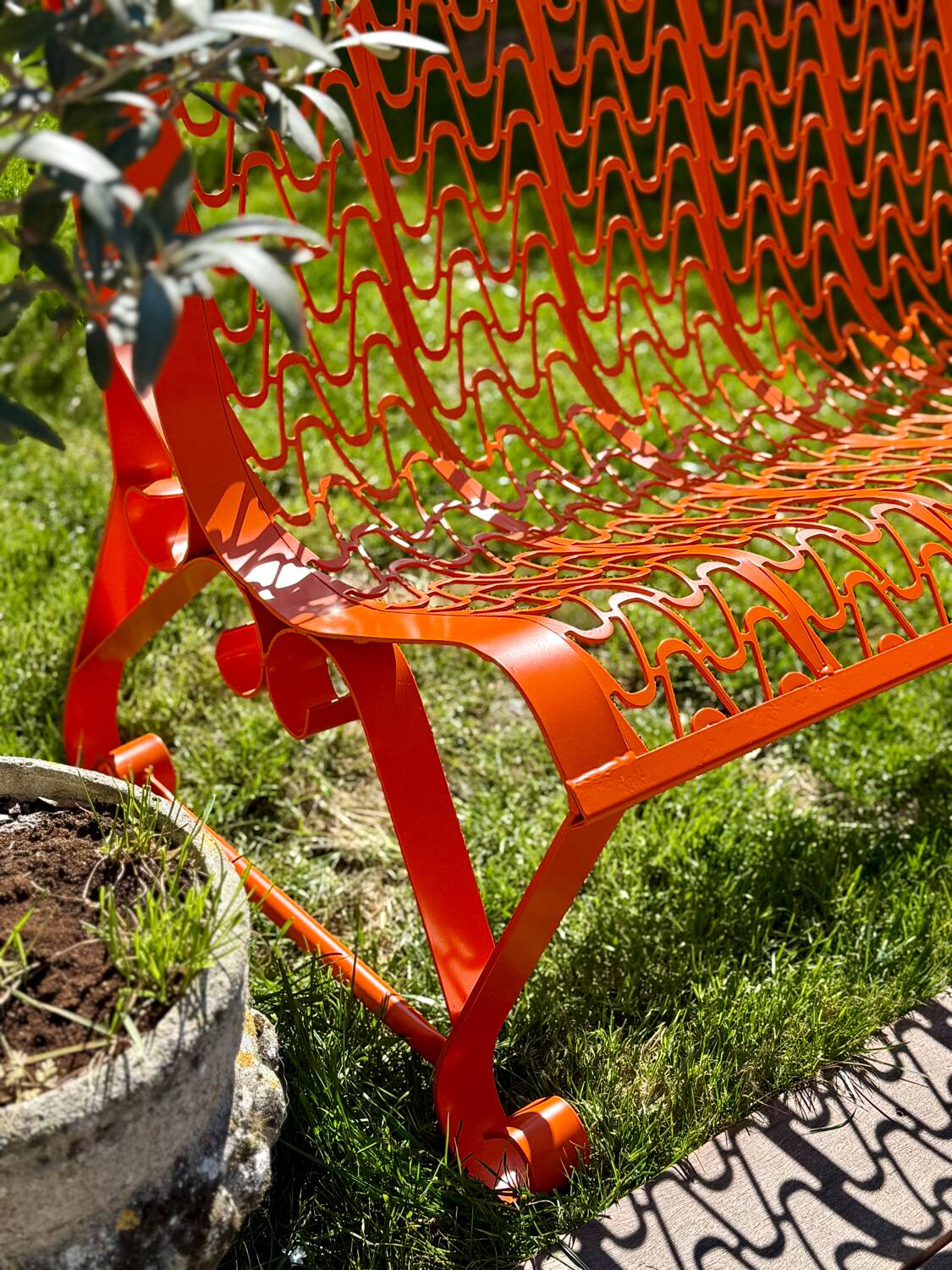 Orange pierced sheet metal bench