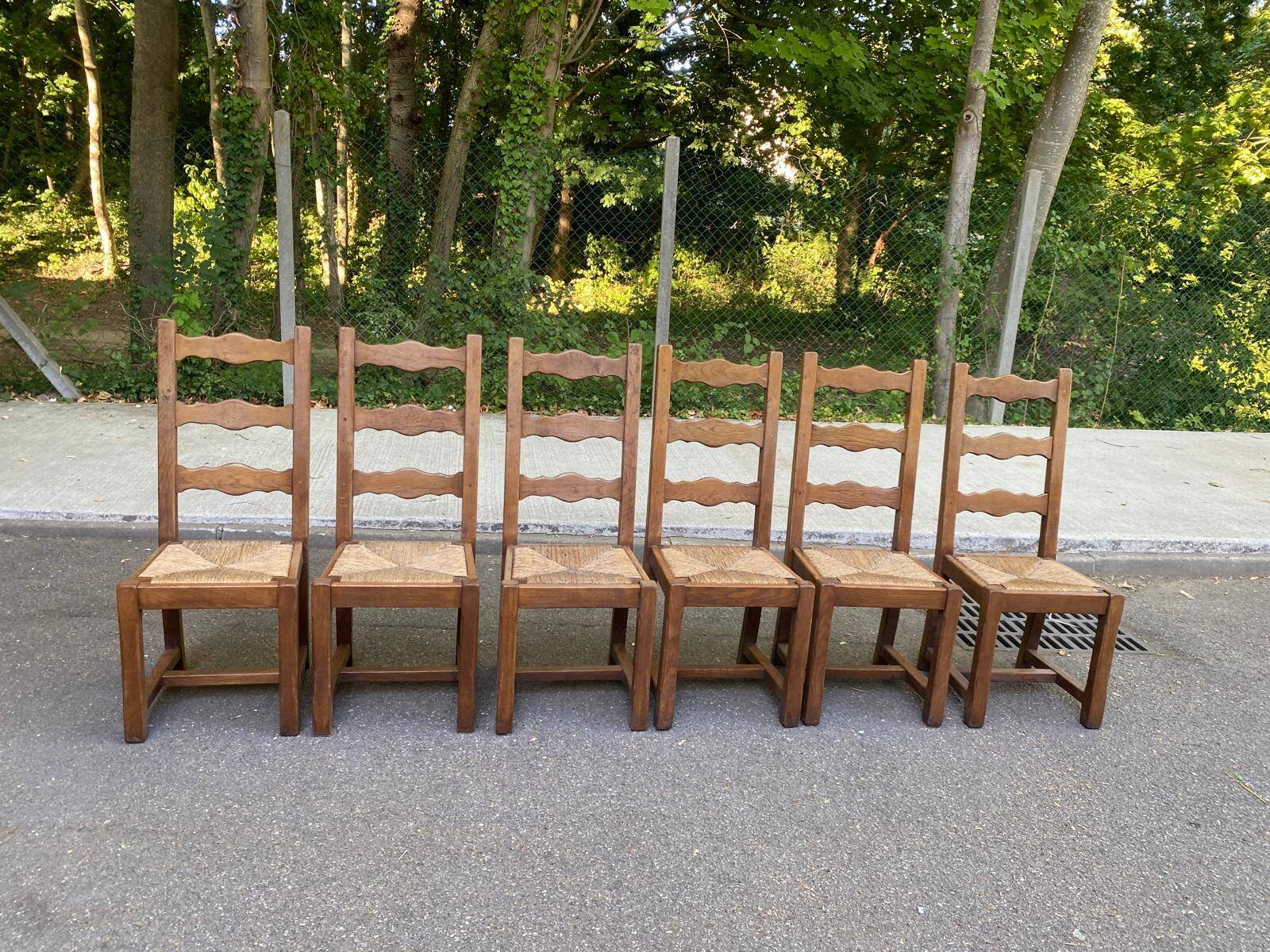 6 solid oak chairs with rush seats in a country style.