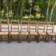 6 solid oak chairs with rush seats in a country style.