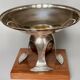 Art deco cut rosewood sphere enclosed in silver metal foot