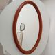 Vintage oval wooden mirror "caramel" from the 1960s.