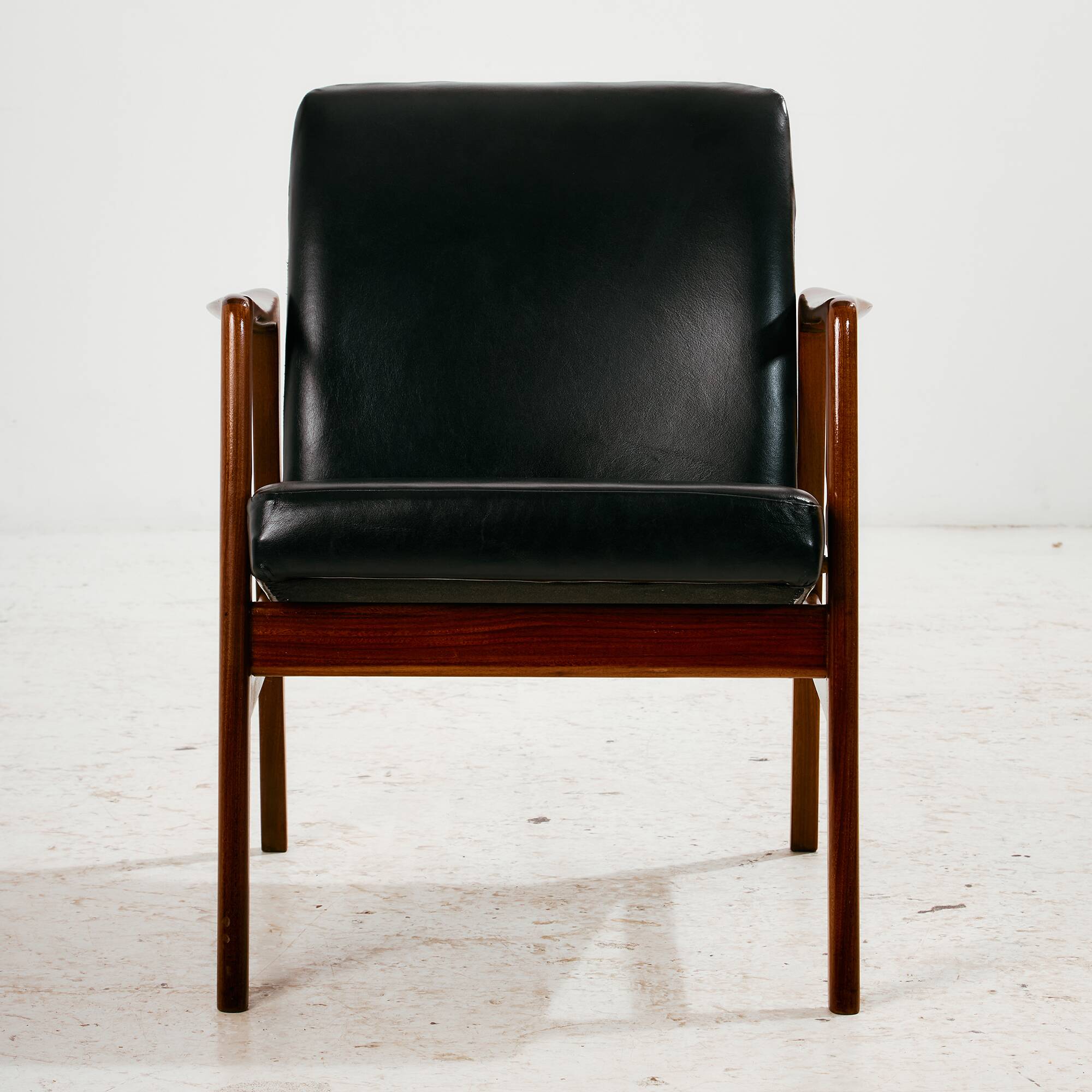 Teak armchair with leather upholstery