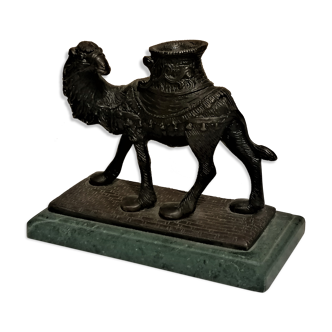 Bronze candle holder in the shape of a camel.