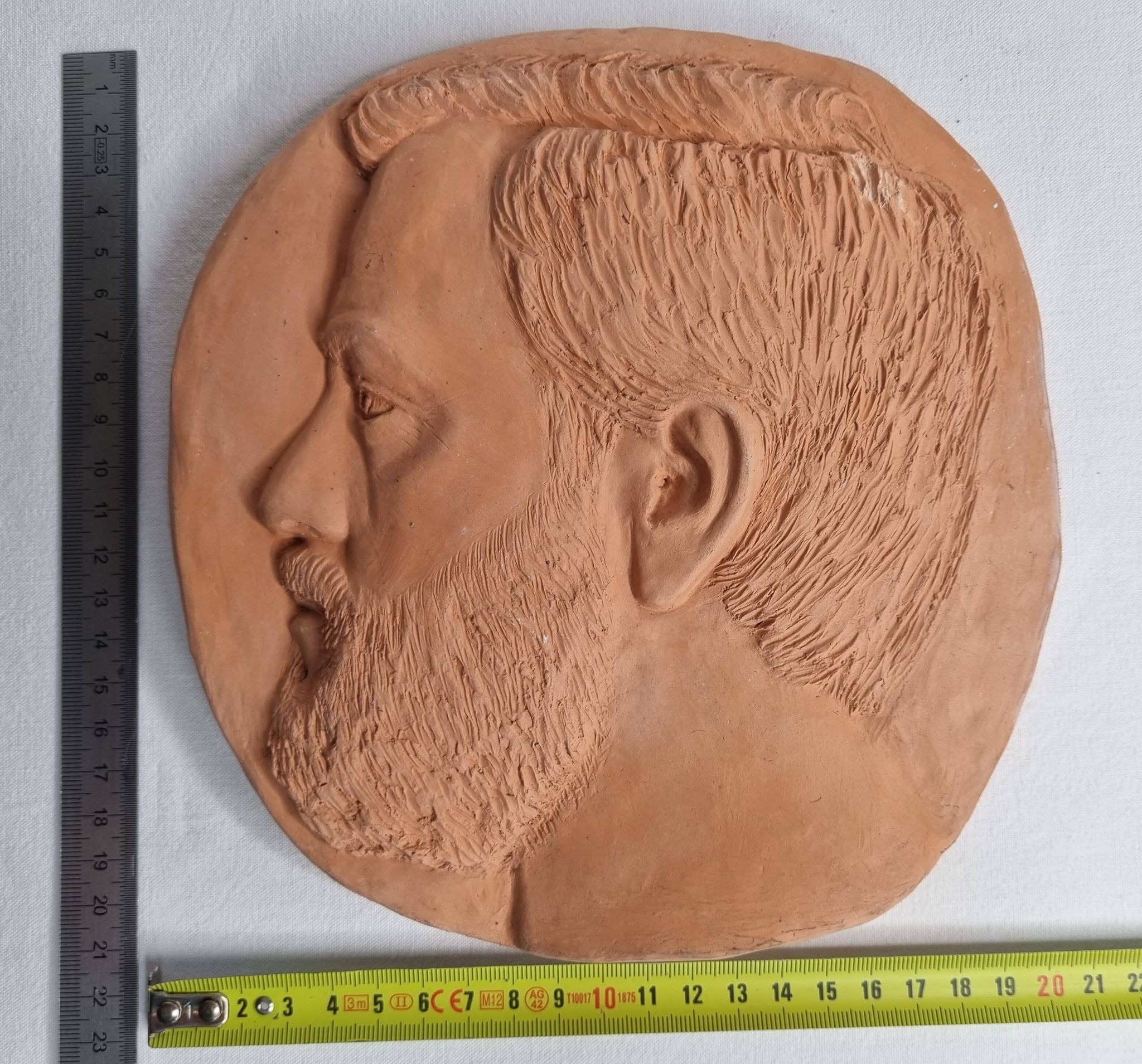 Bas-relief mural in terracotta, profile of a man, signed, 21 x 20 cm, 1984.
