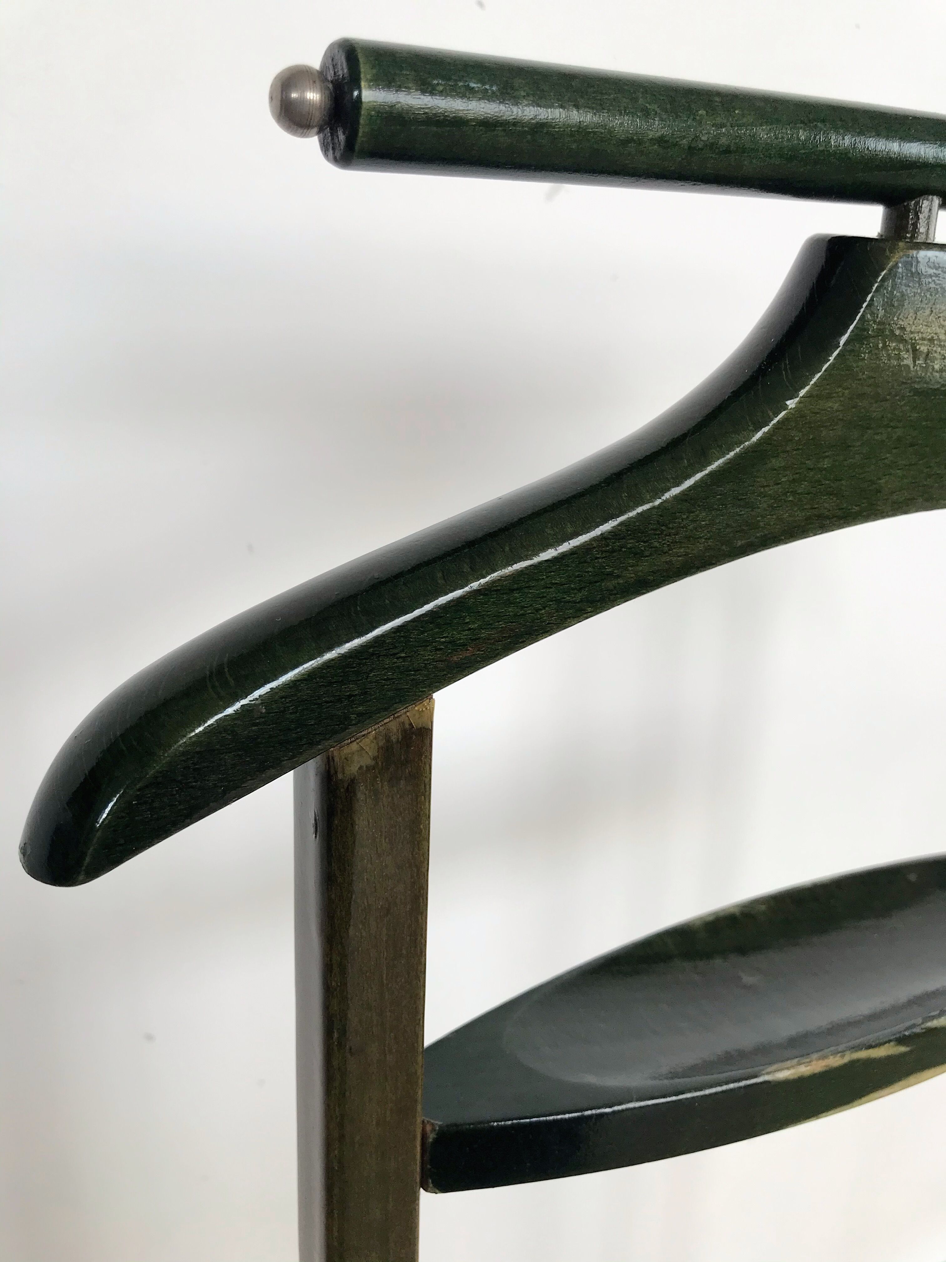 Vintage children's room valet in green varnished wood on roulette