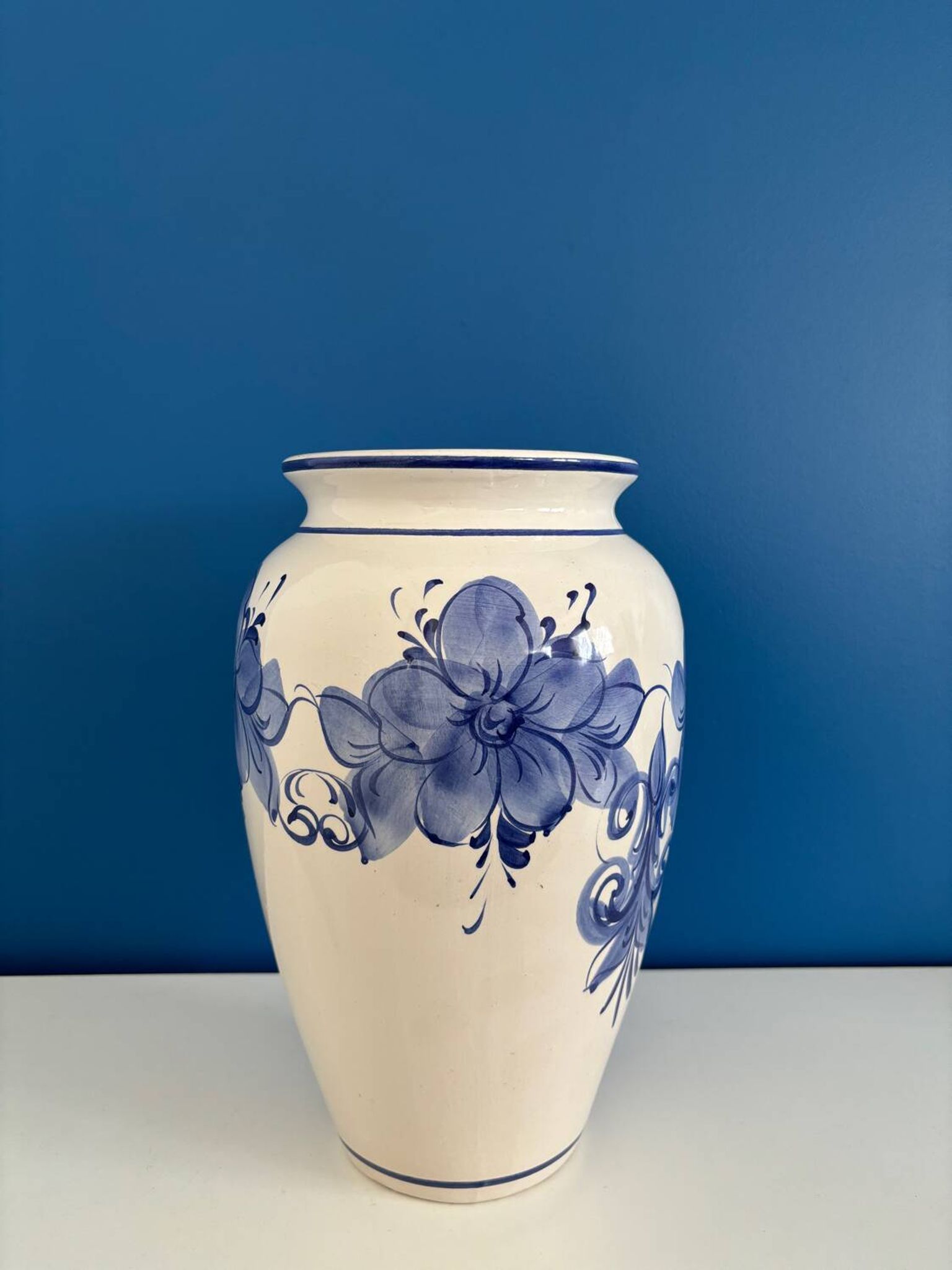Vintage white and blue ceramic vase with floral pattern