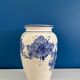 Vintage white and blue ceramic vase with floral pattern