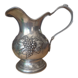 Pewter pitcher decorated with bunch of grapes