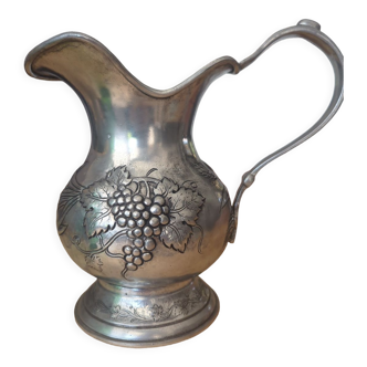 Pewter pitcher decorated with bunch of grapes