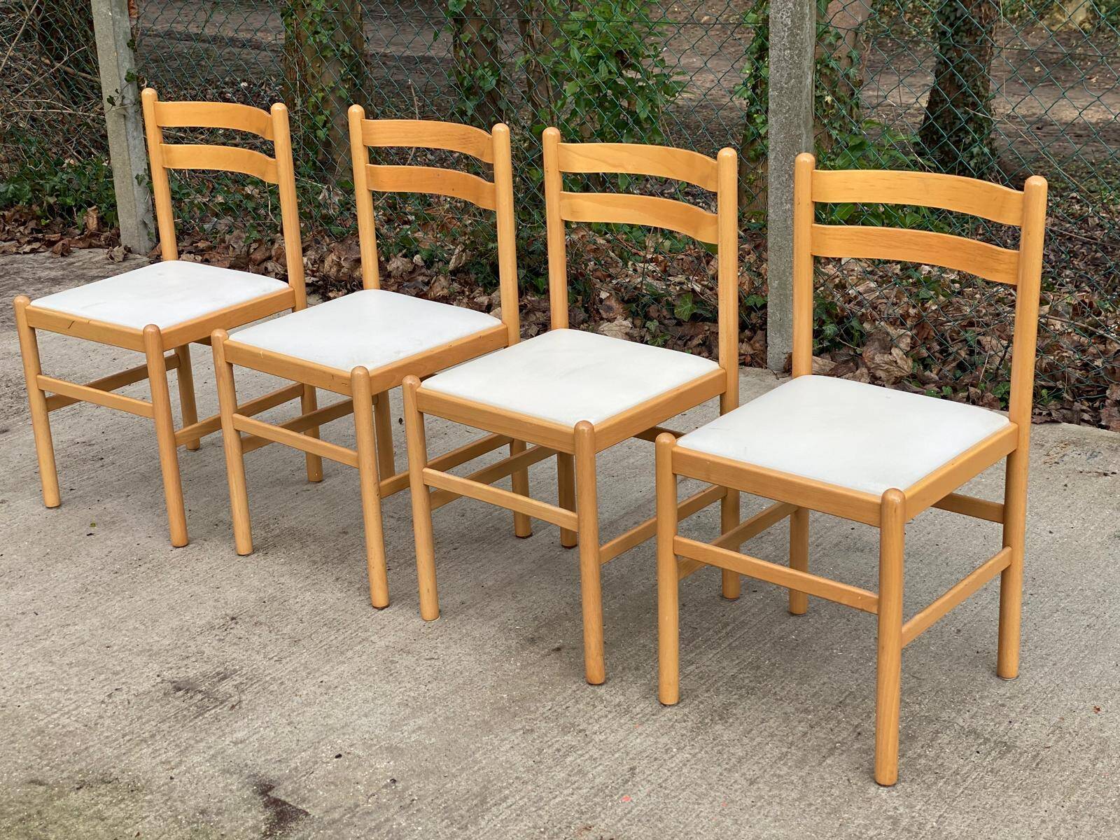 4 solid wood and white leather chairs