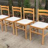 4 solid wood and white leather chairs