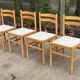 4 solid wood and white leather chairs