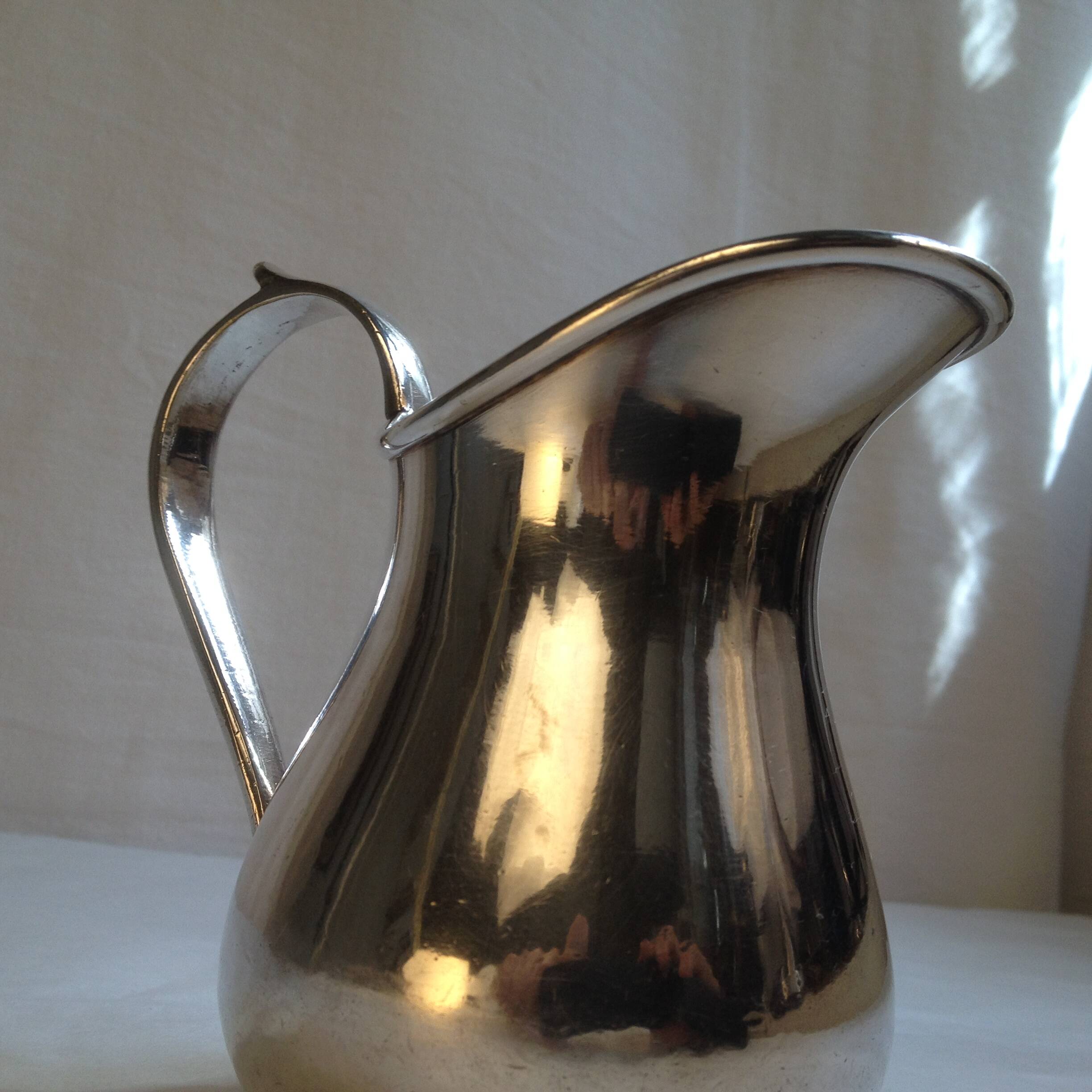 Silver metal milk jug