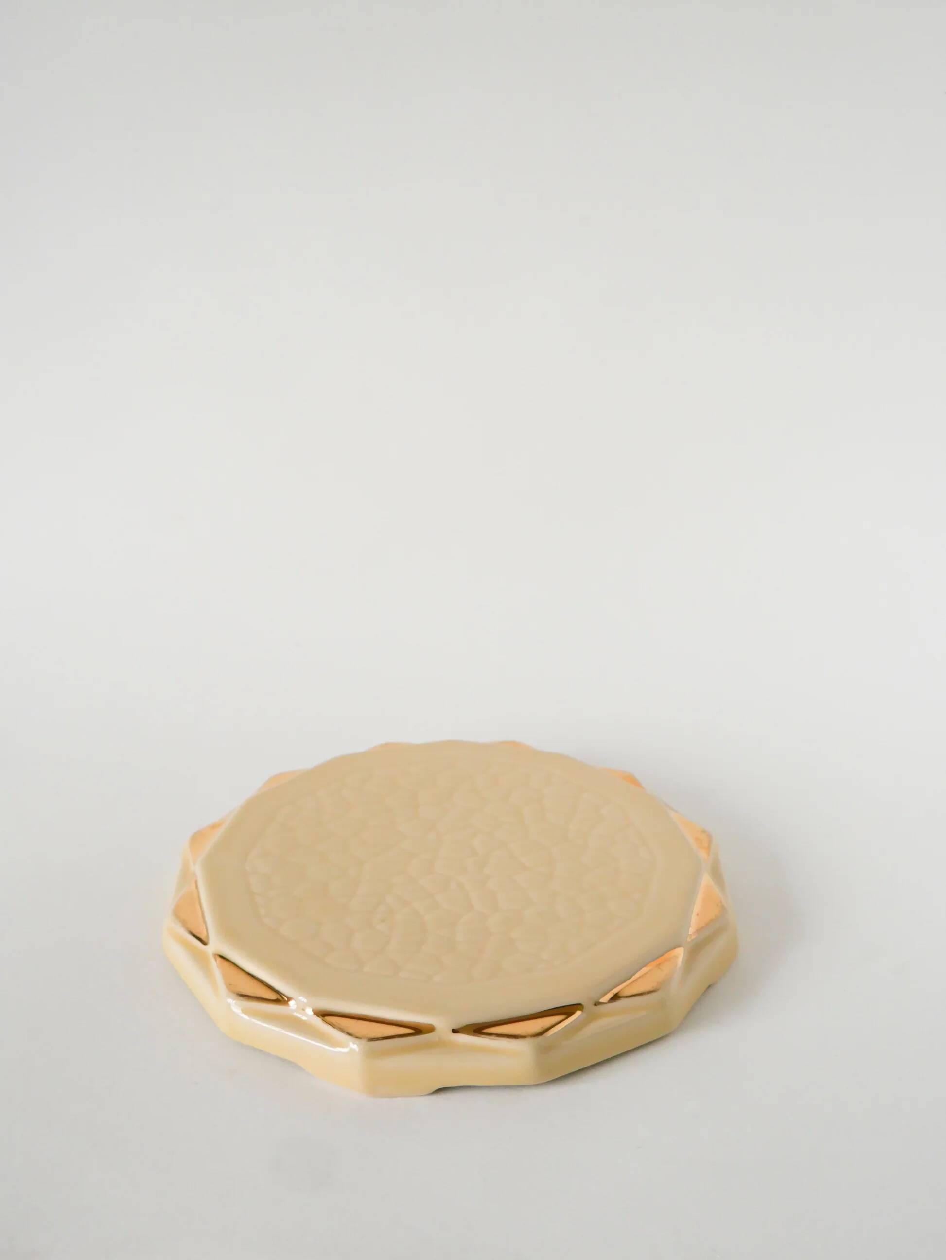 Ceramic trivet, butter yellow and gold, 1960.