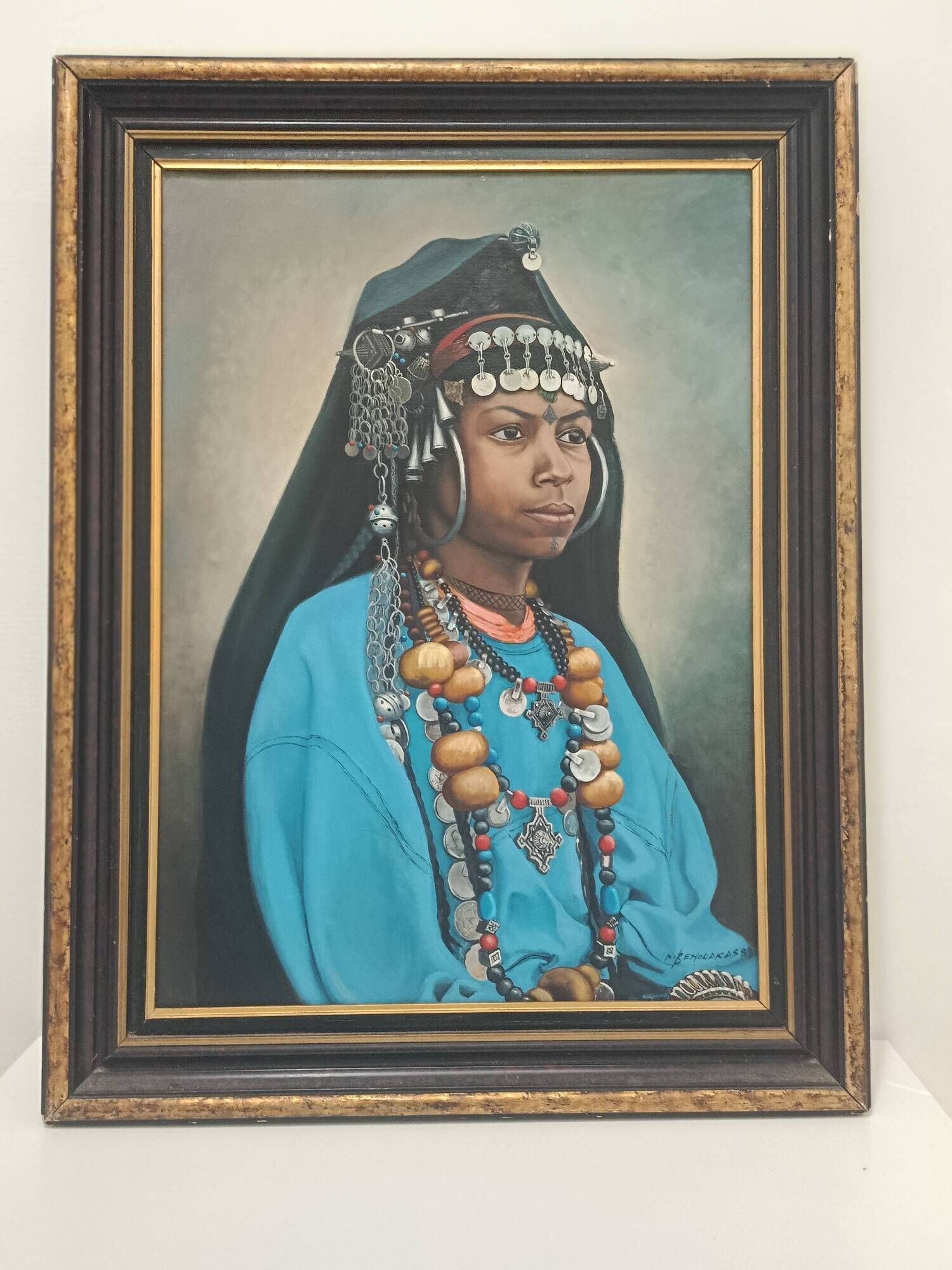 Portrait of a young Moroccan woman in traditional attire and adornments.