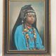 Portrait of a young Moroccan woman in traditional attire and adornments.