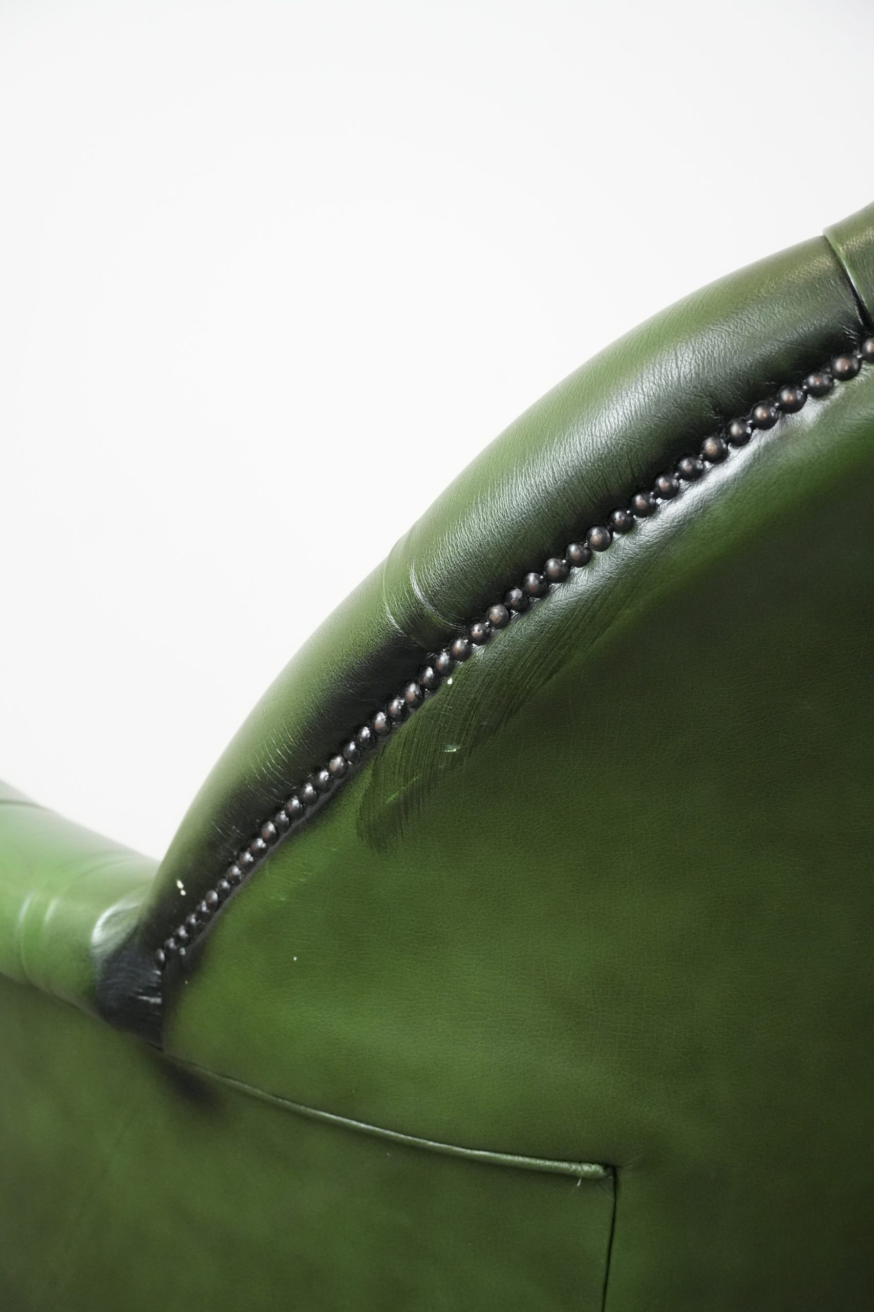 Large green cowhide Chesterfield office chair in English style on wheels