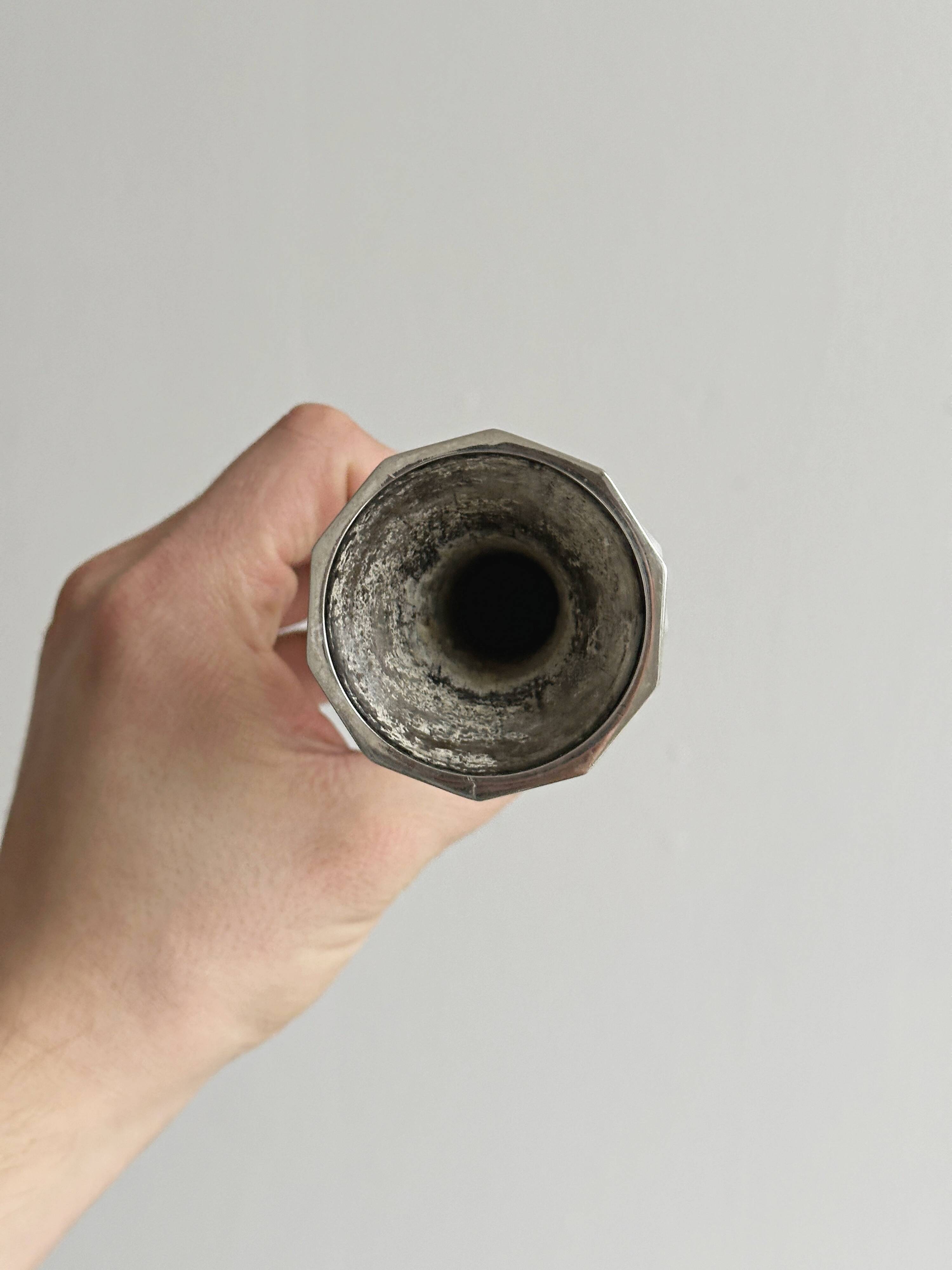 single flower vase or metal candlestick