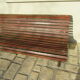 Public bench in wooden slats and cast iron legs