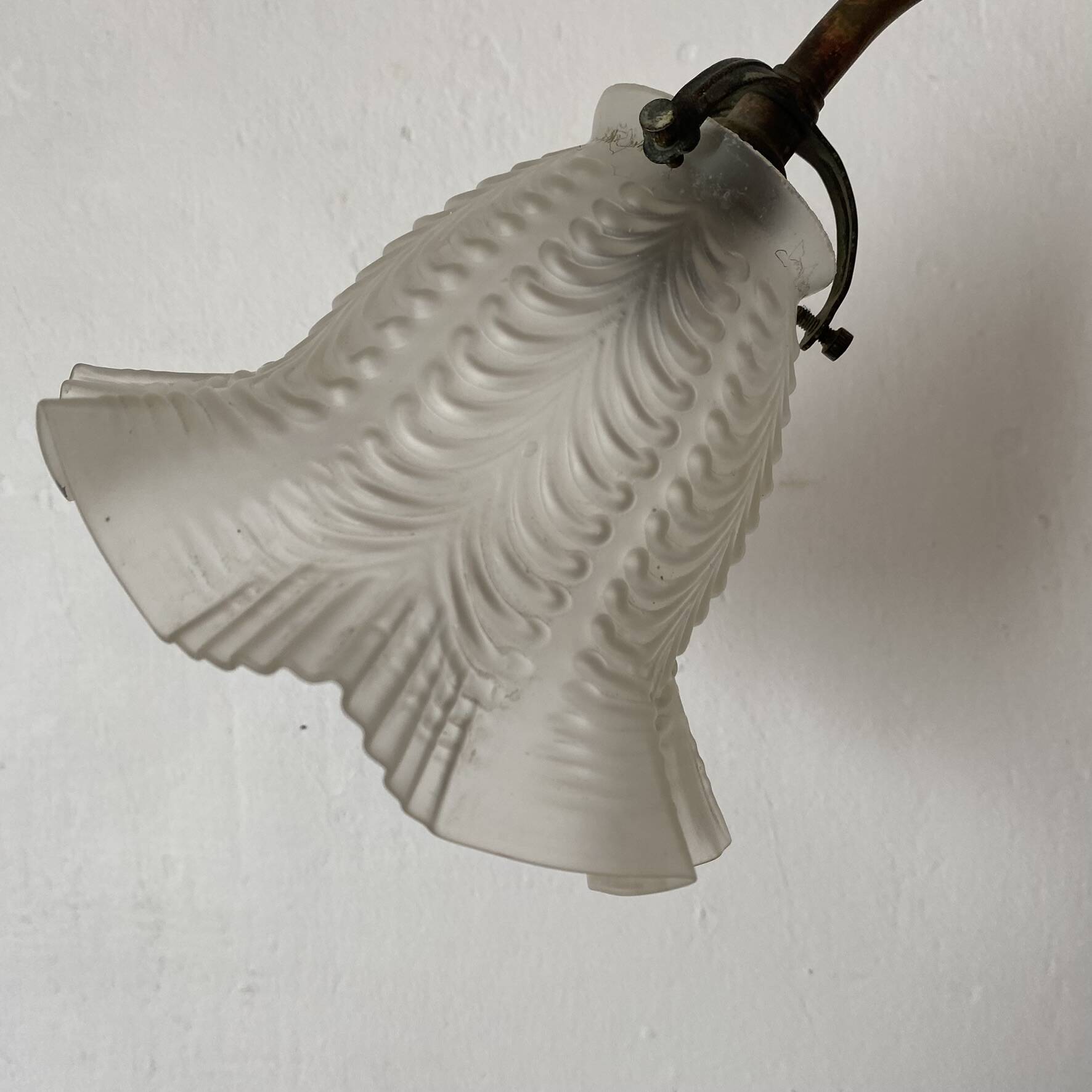 Antique swan neck wall light in brass and porcelain with a glass shade.