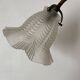 Antique swan neck wall light in brass and porcelain with a glass shade.