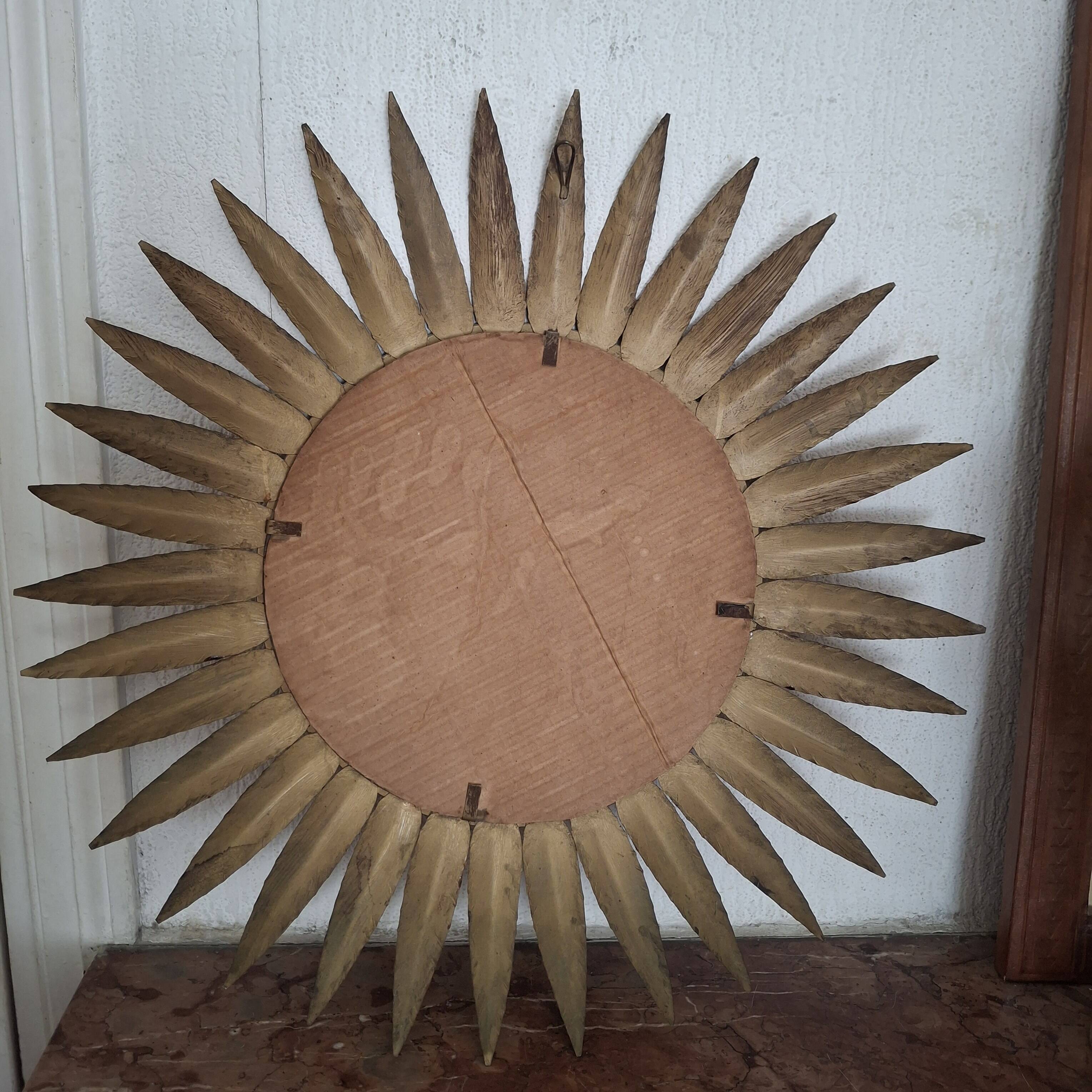 Large sun mirror in gilded metal. 1960