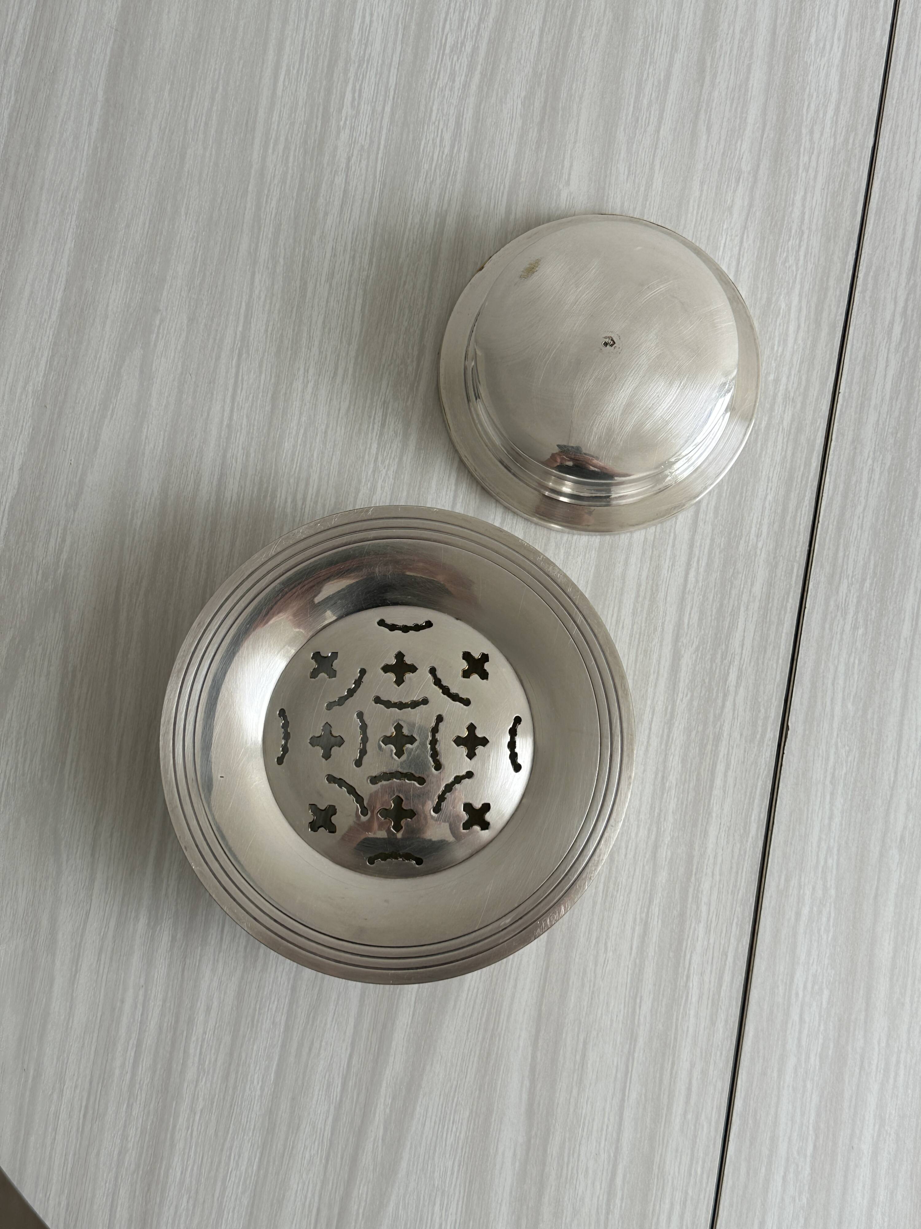 Antique butter dish in shiny metal