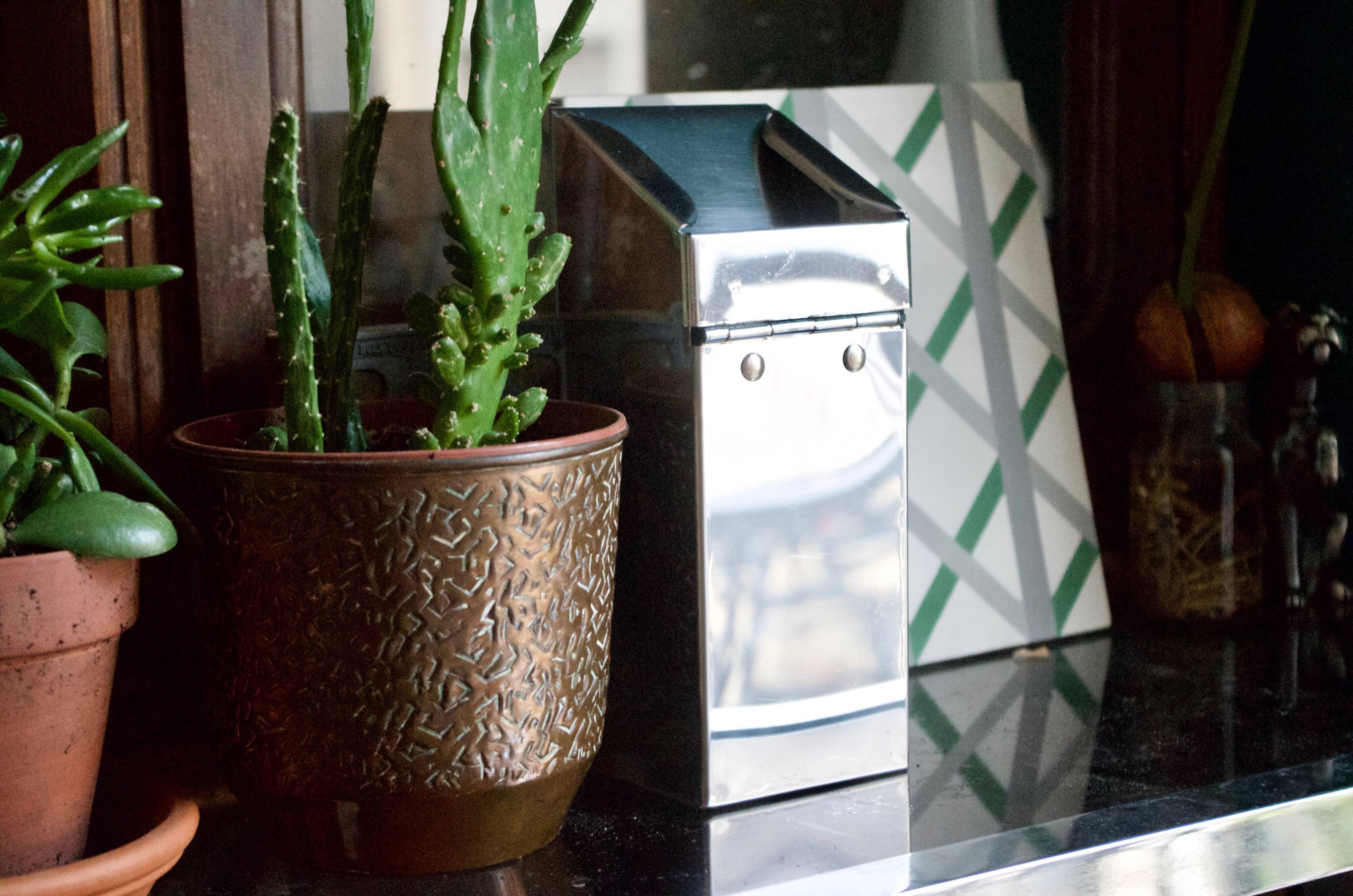 Vintage wall ashtray in shiny metal industrial style