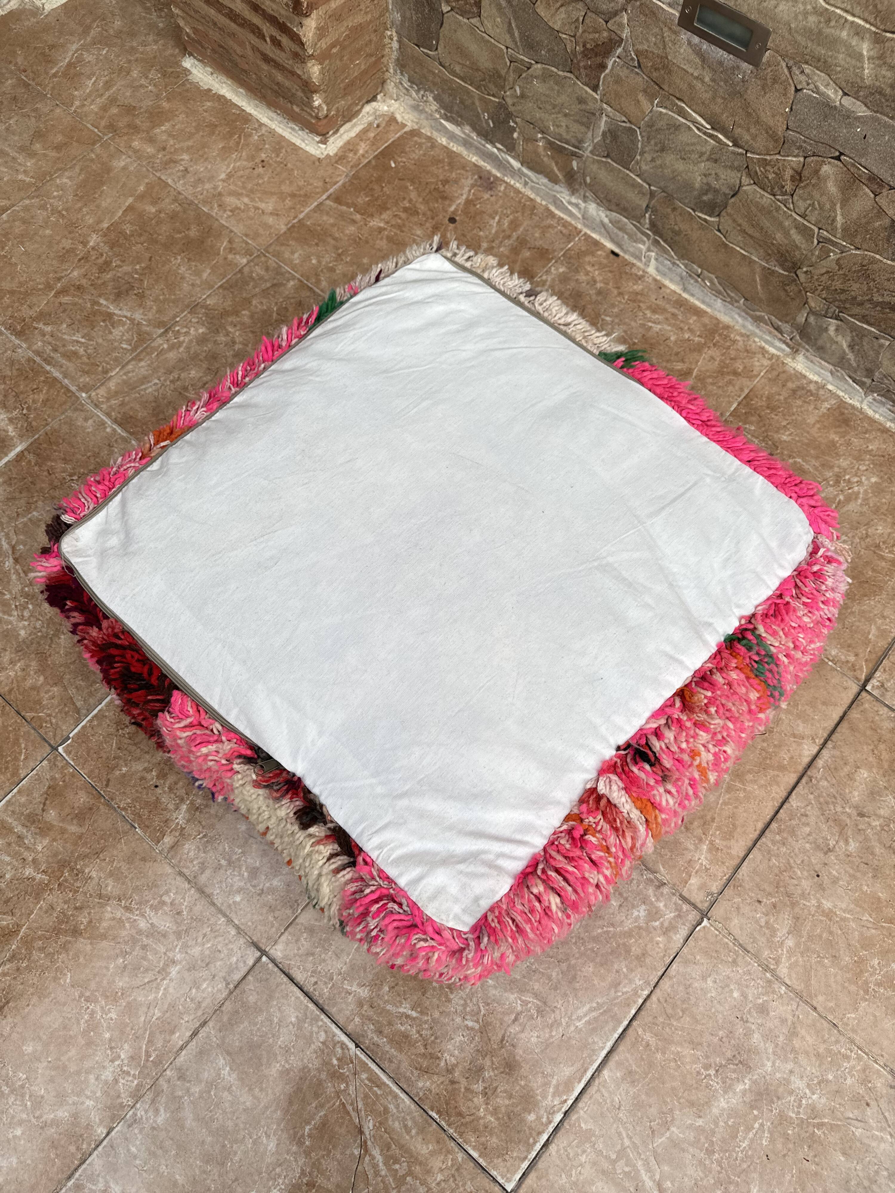 Berber floor pouf: Handwoven Moroccan wool cushion.
