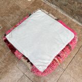 Berber floor pouf: Handwoven Moroccan wool cushion.