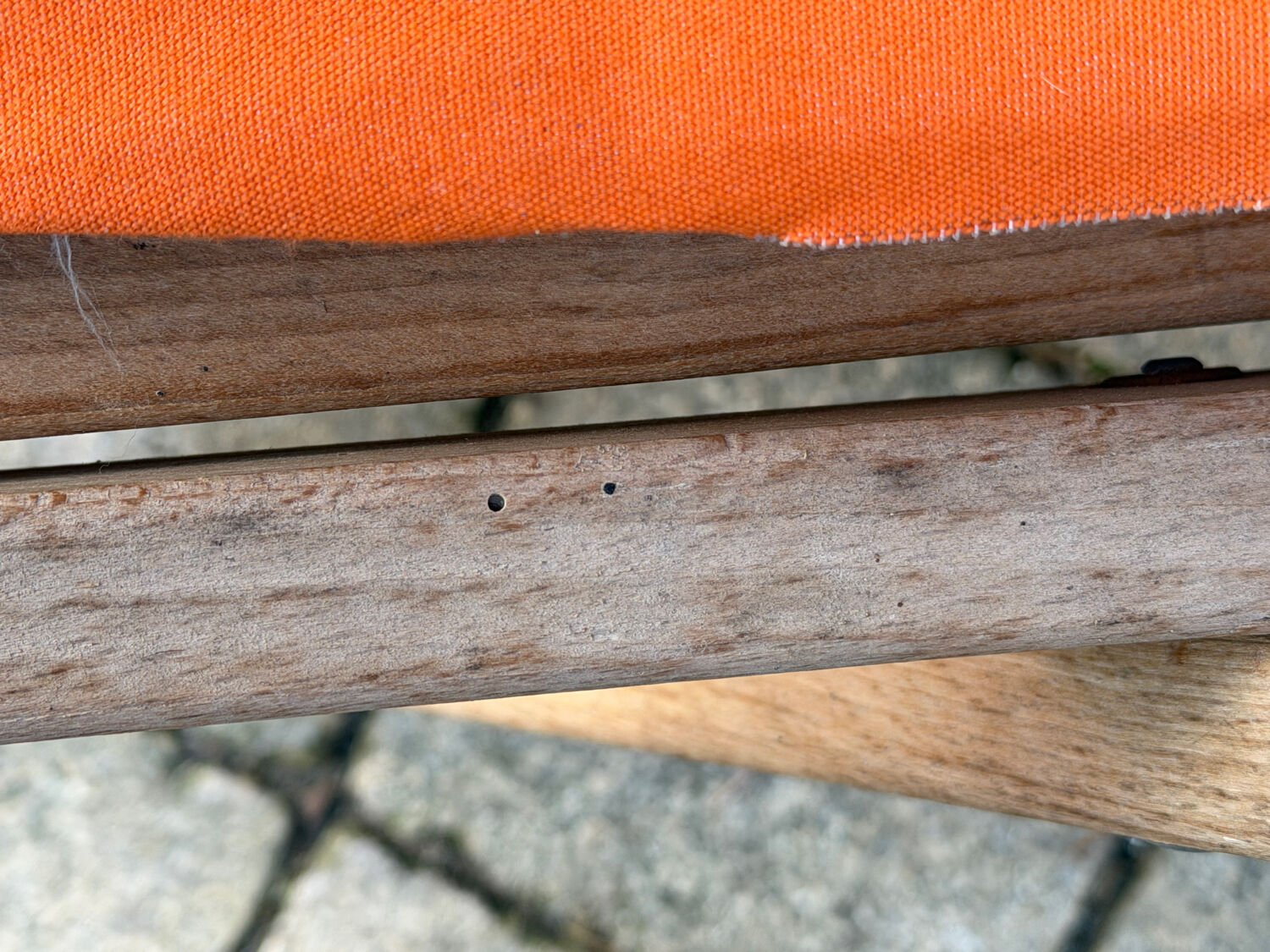 Vintage deck chair with orange and grey striped fabric, original patina.