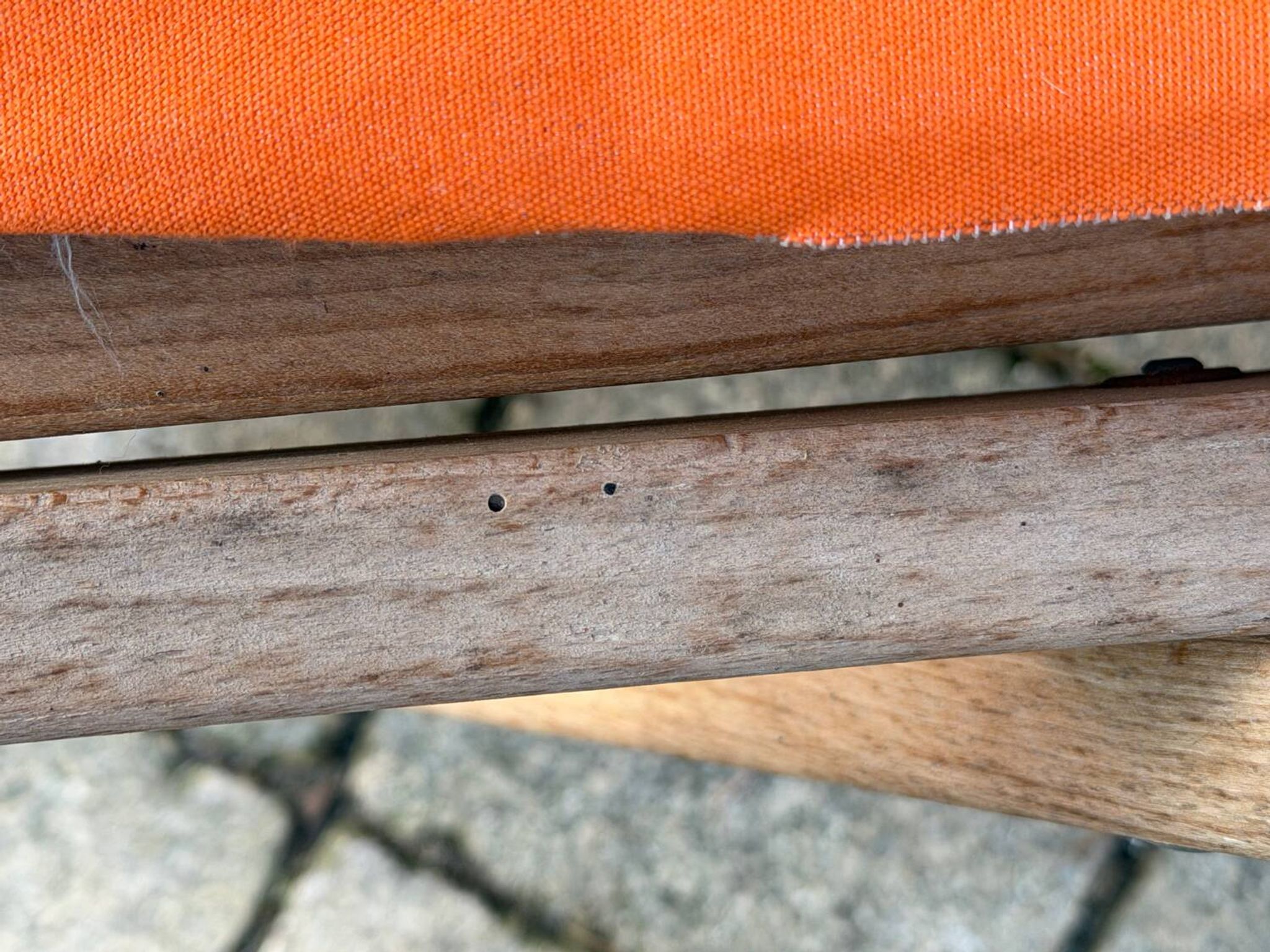 Vintage deck chair with orange and grey striped fabric, original patina.