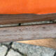 Vintage deck chair with orange and grey striped fabric, original patina.