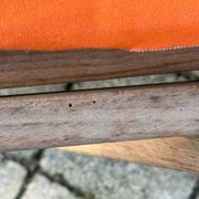 Vintage deck chair with orange and grey striped fabric, original patina.