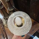 Vintage wall light in gilded bronze with a cracked glass globe.