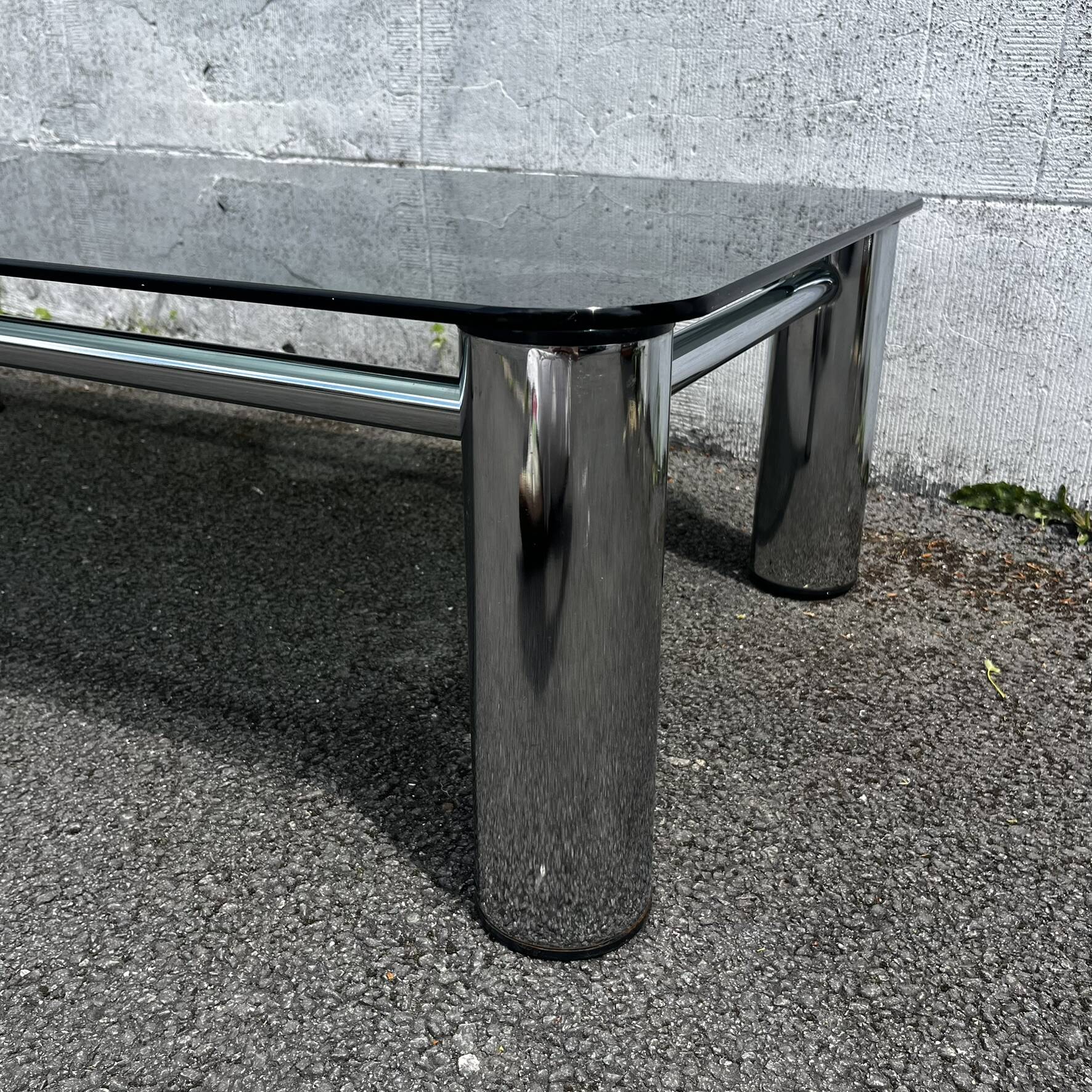 Vintage coffee table with smoked glass and chrome.