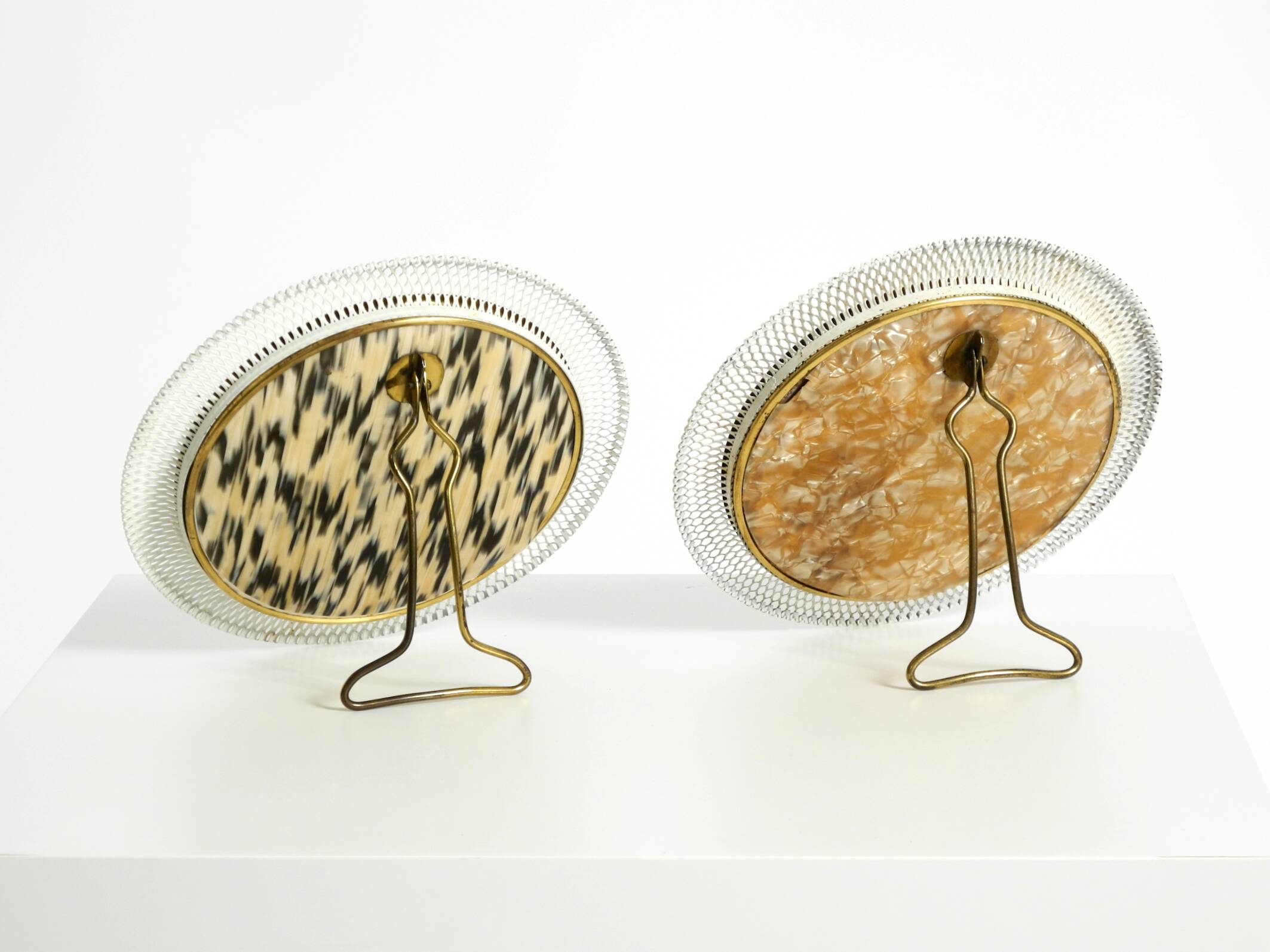 Pair of rare small Mid Century Modern table mirrors with expanded metal fra